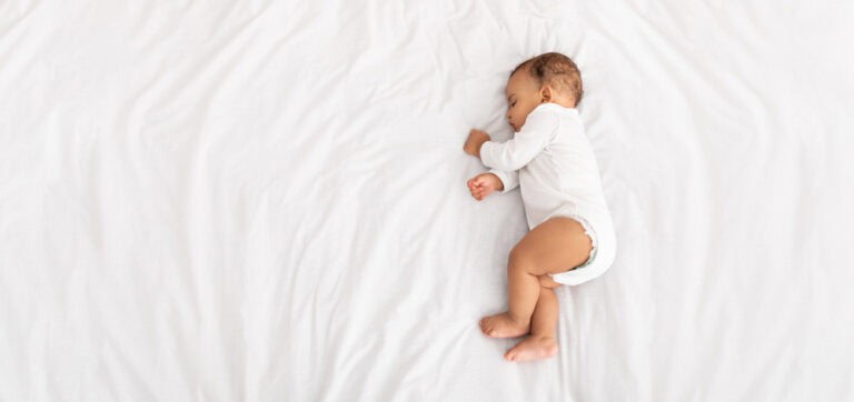 Sleeping baby boy illustrating importance of preventing baby bottle tooth decay