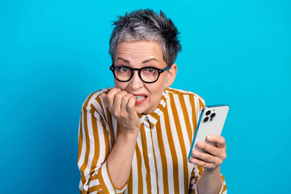 Woman biting nails illustrating bad habits that harm oral hygiene and dental health