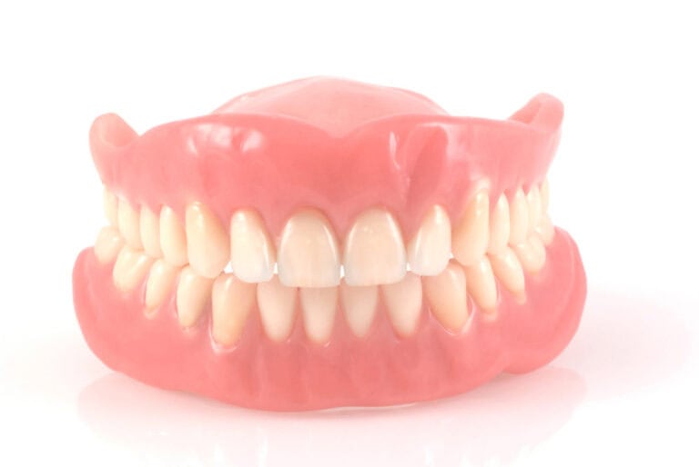 White dental dentures isolated on white background — complete denture guide Colorado Springs, CO