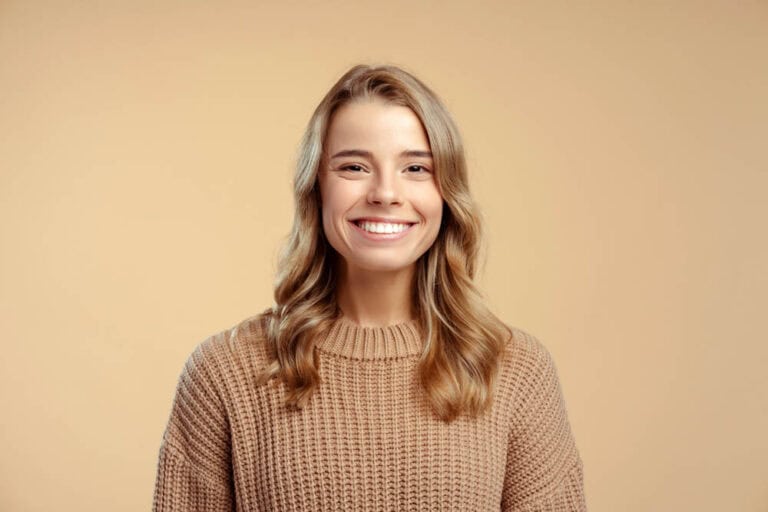 Woman with radiant smile showcasing cosmetic dentistry transformation in Colorado Springs, CO