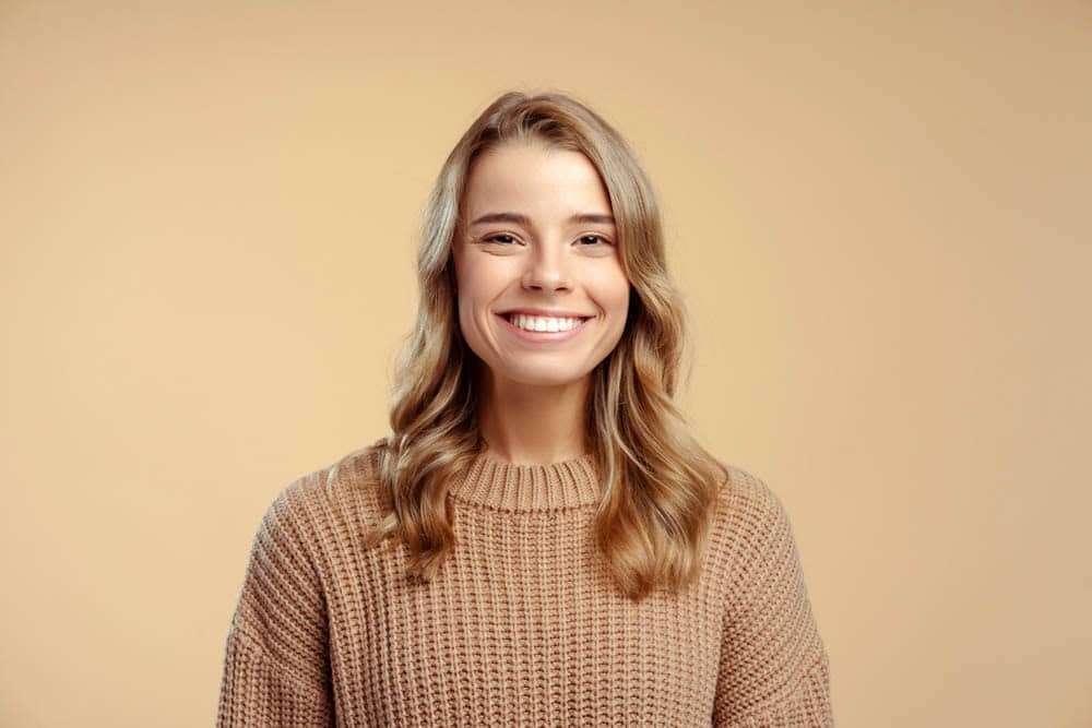 Woman with radiant smile showcasing cosmetic dentistry transformation in Colorado Springs, CO
