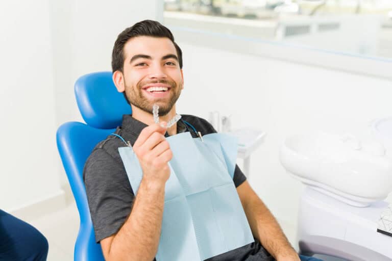 Young man wearing SureSmile clear aligners during orthodontic appointment in Colorado Springs, CO